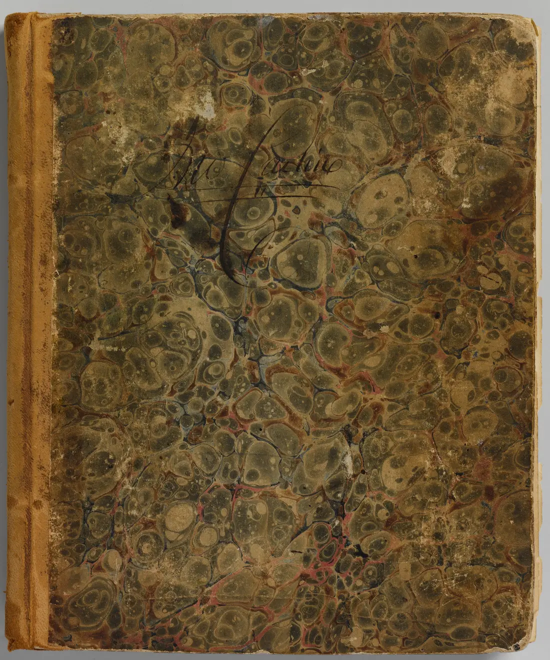 Marbled cover of a nineteenth-century account book ledger, with a handwritten title across the front.